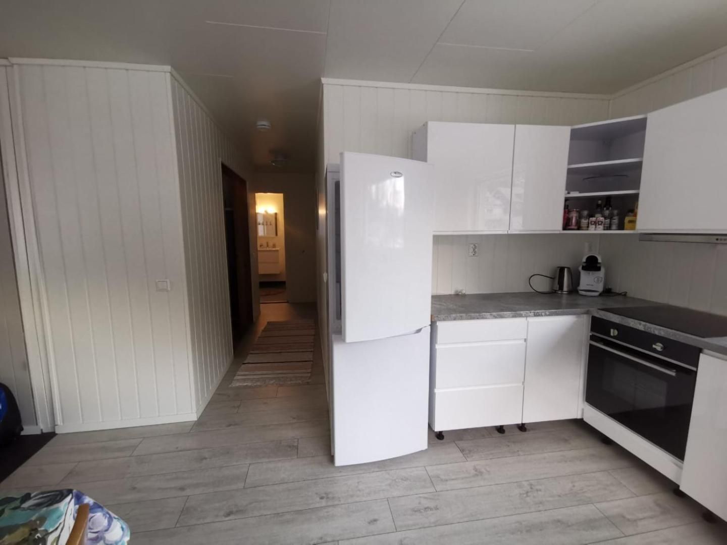 White kitchen with oven and fridge