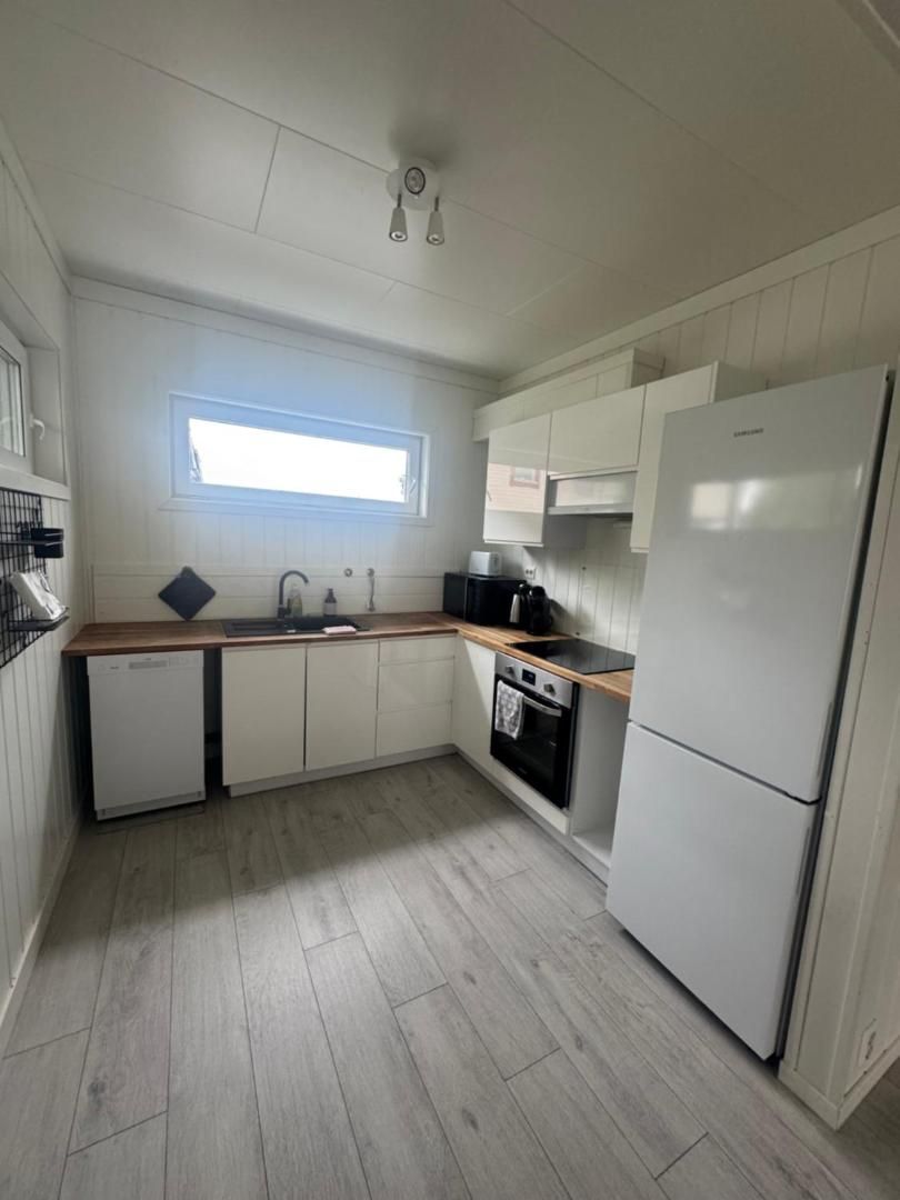 White kitchen with oven, fridge and dishwasher