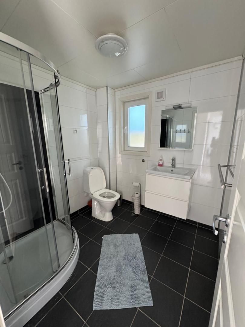 Bathroom with shower cubicle, toilet and basin