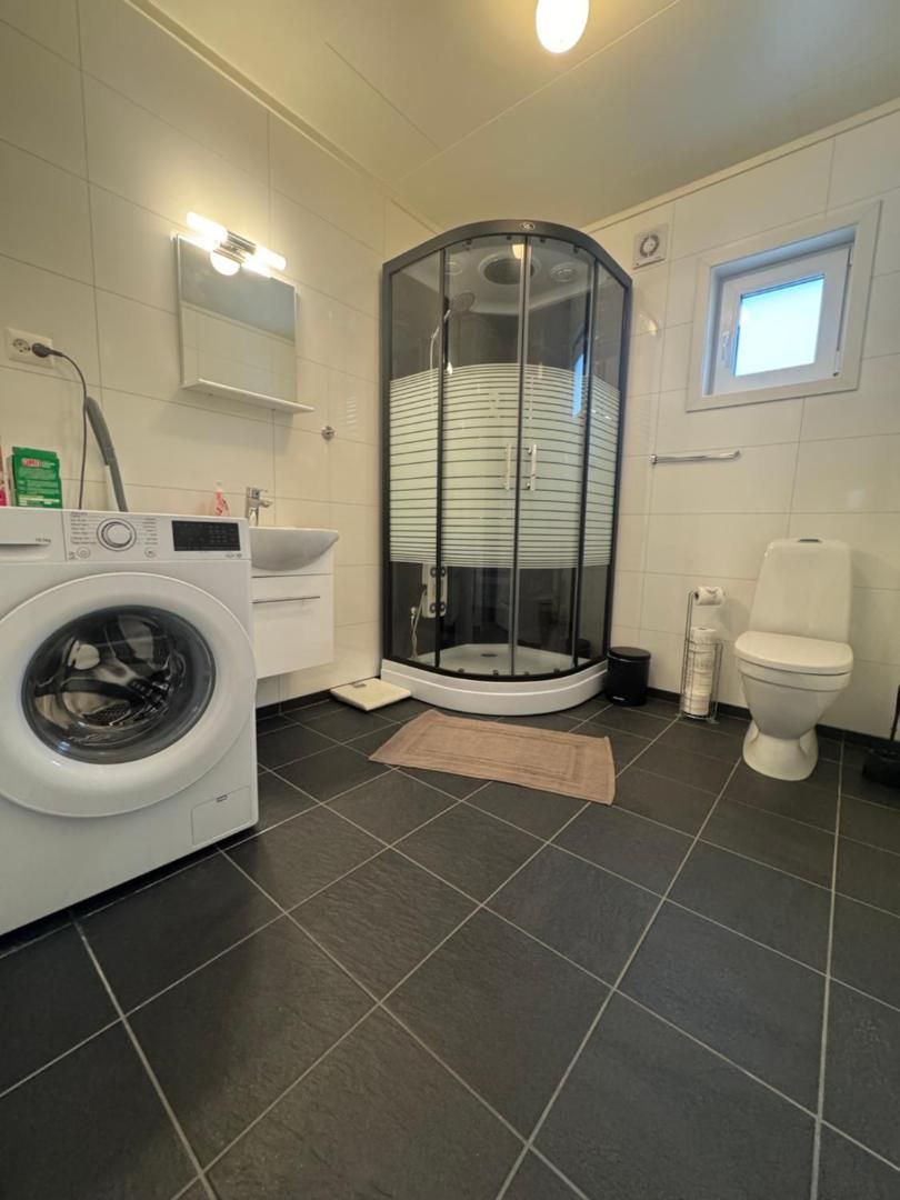 Second bathroom with shower cubicle and washing machine