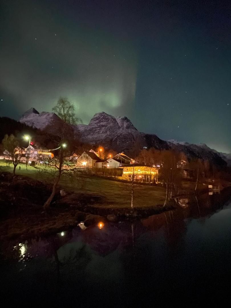 Northern lights over the village and the lake